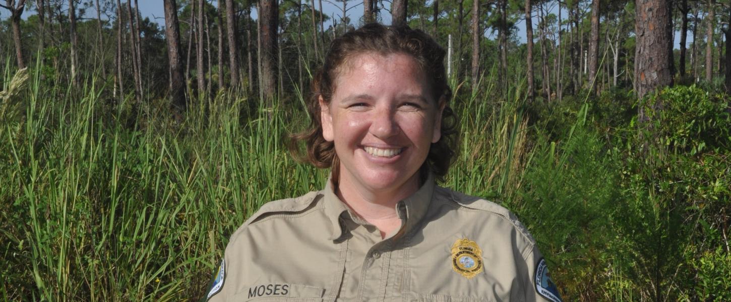 Image of Park Manager Katie Moses with background of pine trees