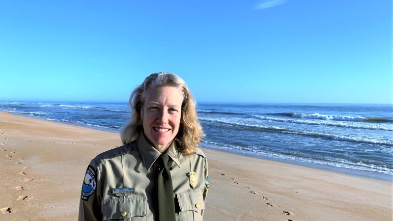 Lynne Flannery standing on the beach at Gamble Rogers Memorial State Recreation Area at Flagler Beach.