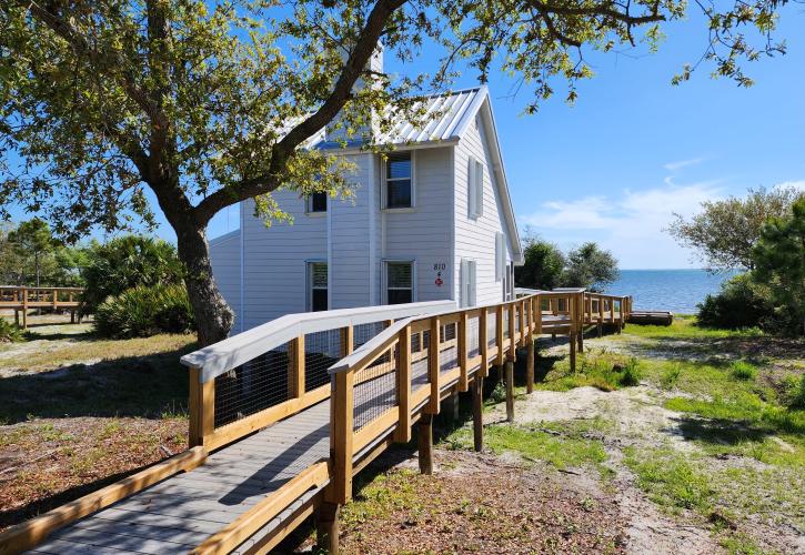 A boardwalk leads to one of eight cabins with a view of St. Joseph Bay.