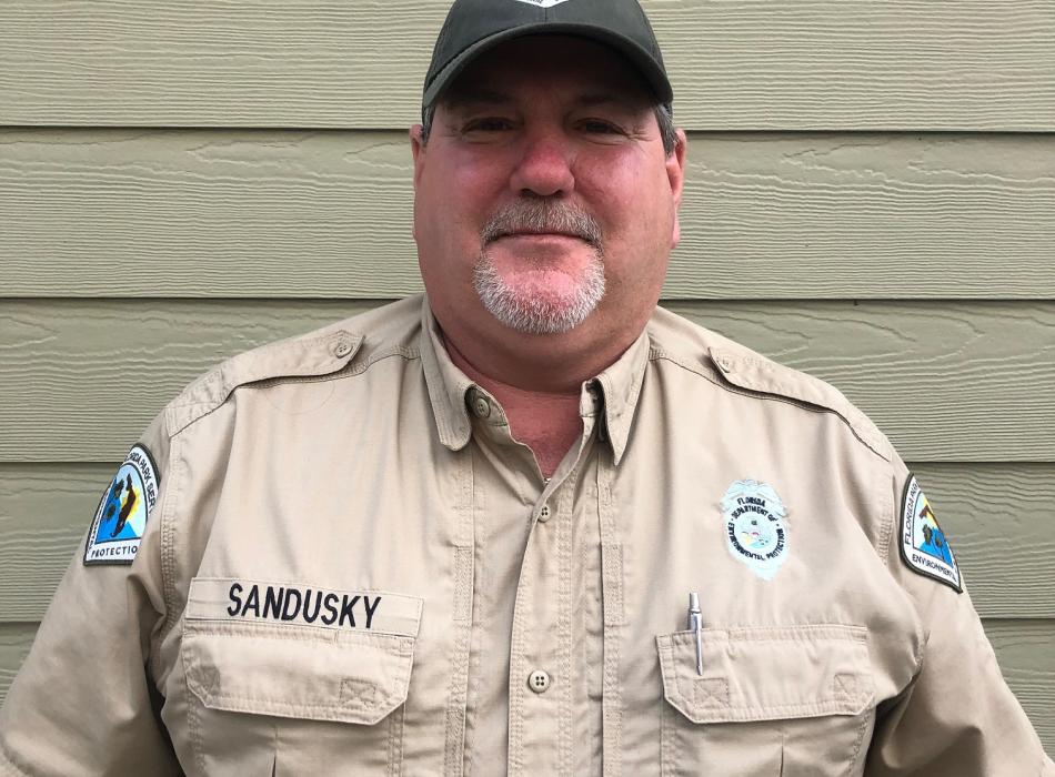 Park Services Specialist Ricky Sandusky smiles ready to greet park visitors. 
