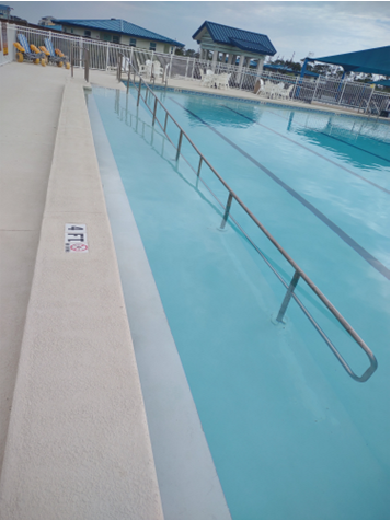 A swimming pool with a ladder</p>
<p>Description automatically generated