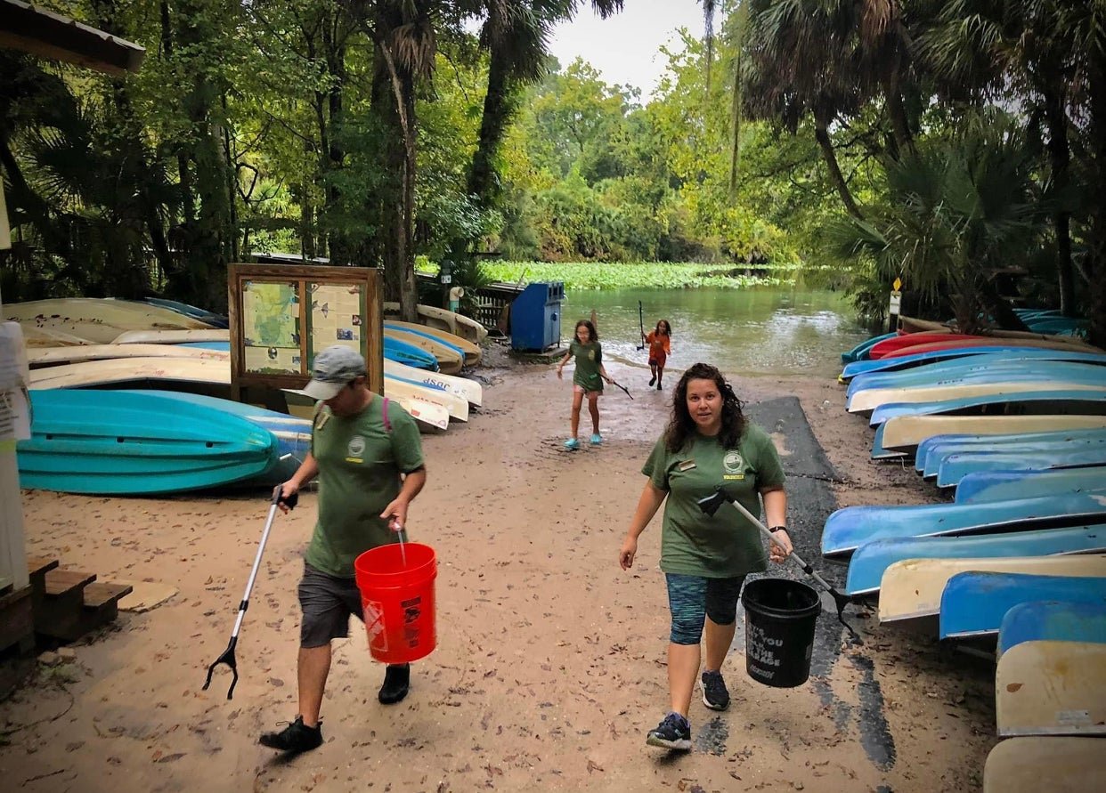 Members of the Nieves family pick up litter.