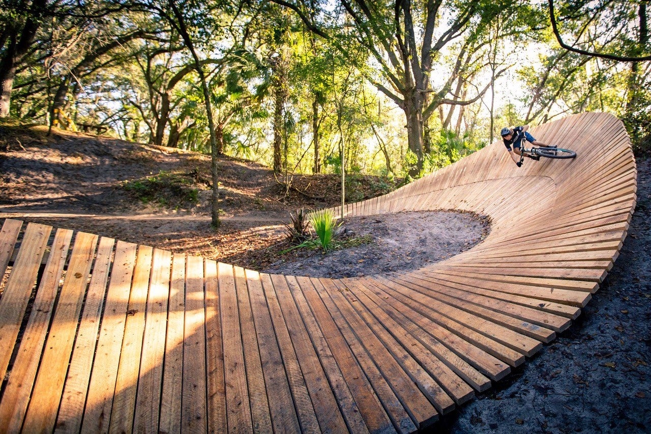 Mountain bike rider on wooden berm turn