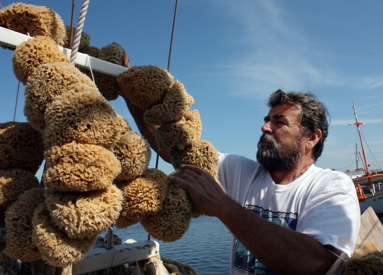 A photo of a man on a sponge boat