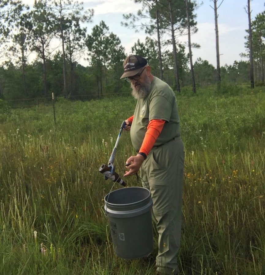 Dale Wheelis picks up litter at the park.