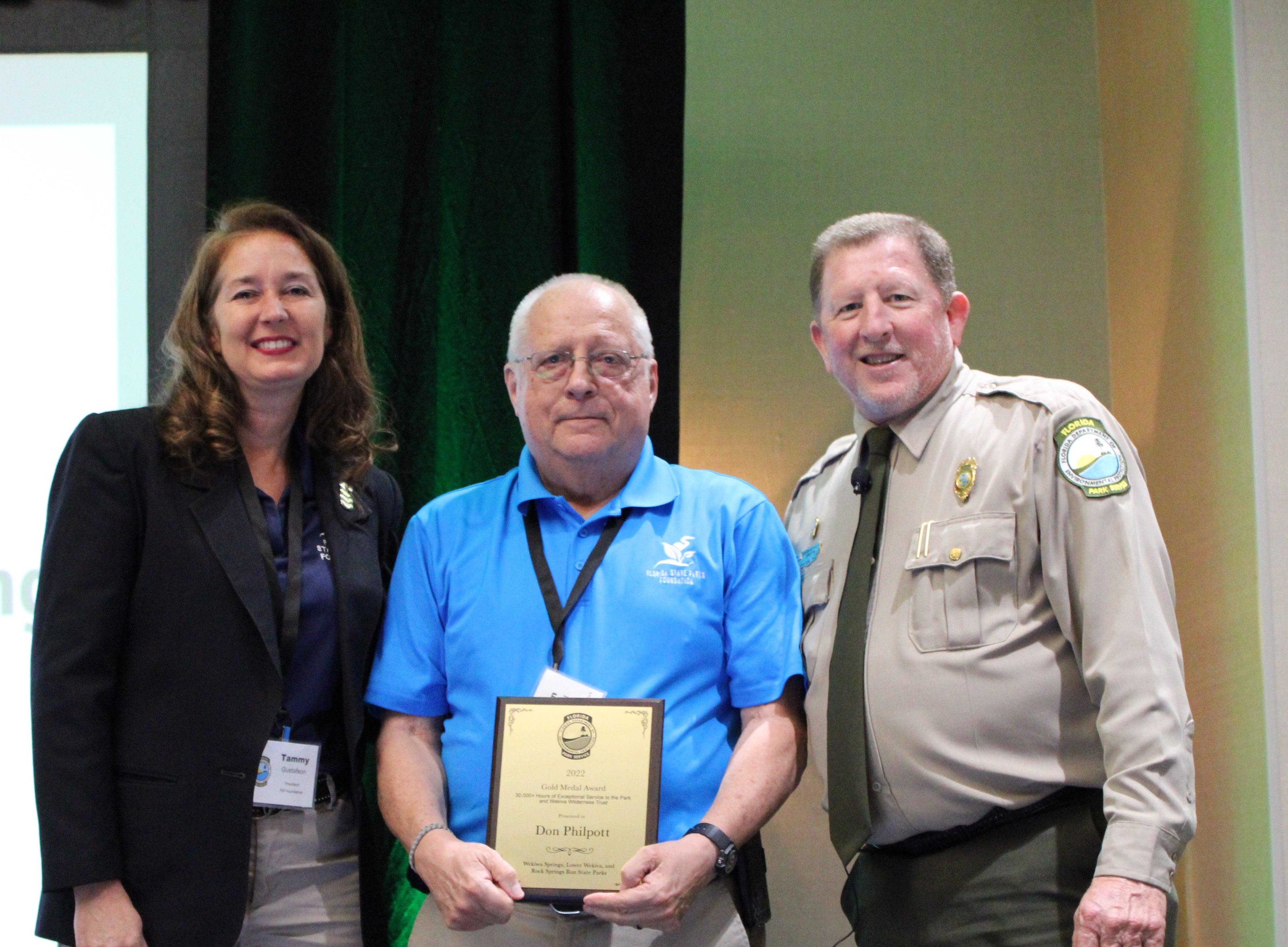 Don Philpott receives the award with Tammy Gustafson and Chuck Hatcher.