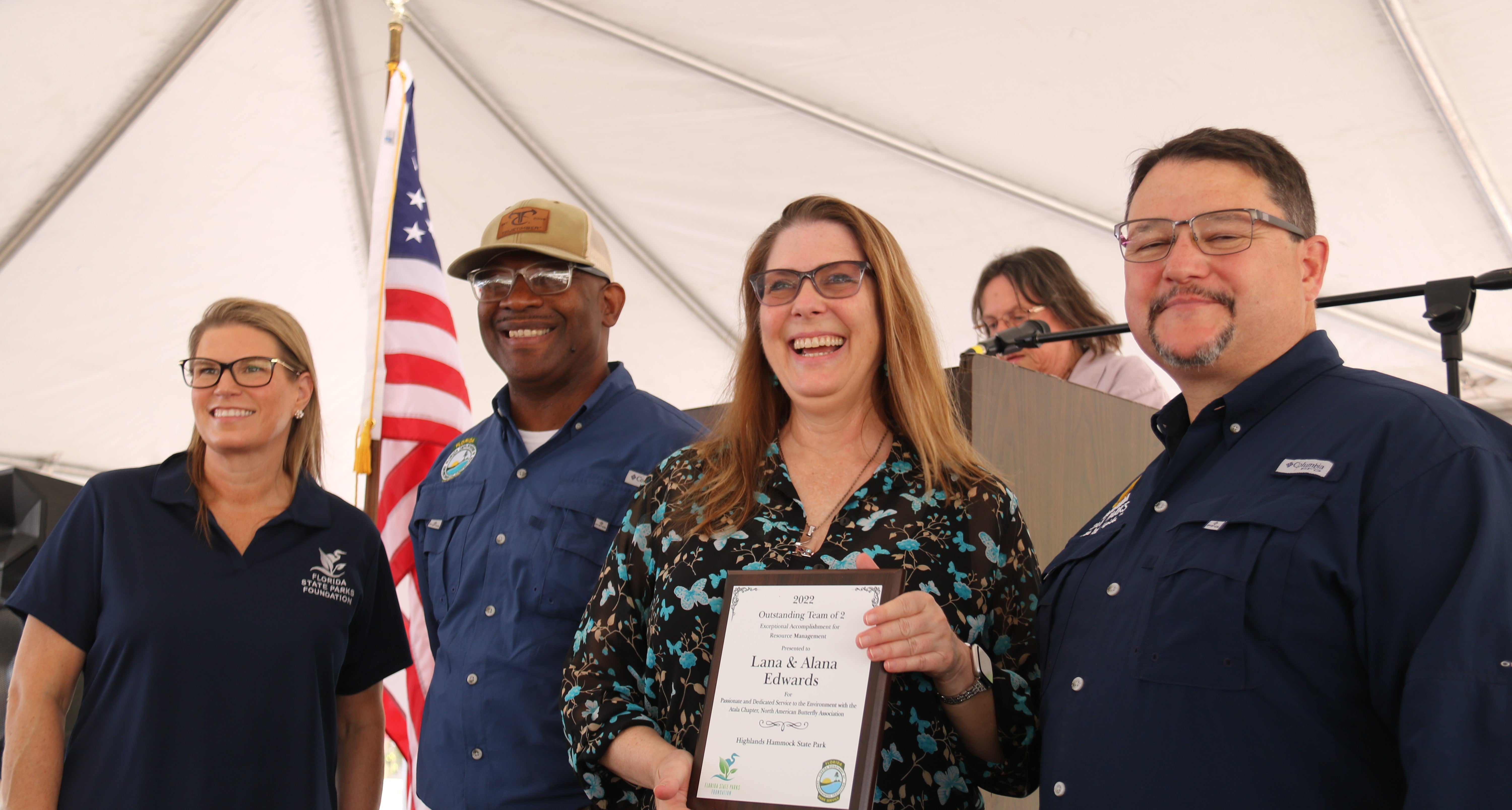 Ms. Edwards receives the award from Emily Lewis, BJ Givens and Brian Fugate.