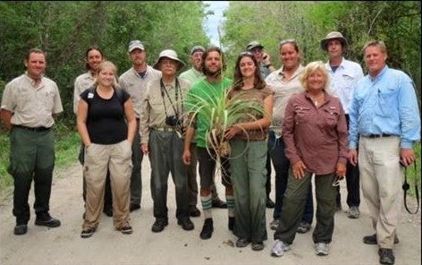 The Giant Airplant Rescue Team poses with one of the plants it gathered to save.