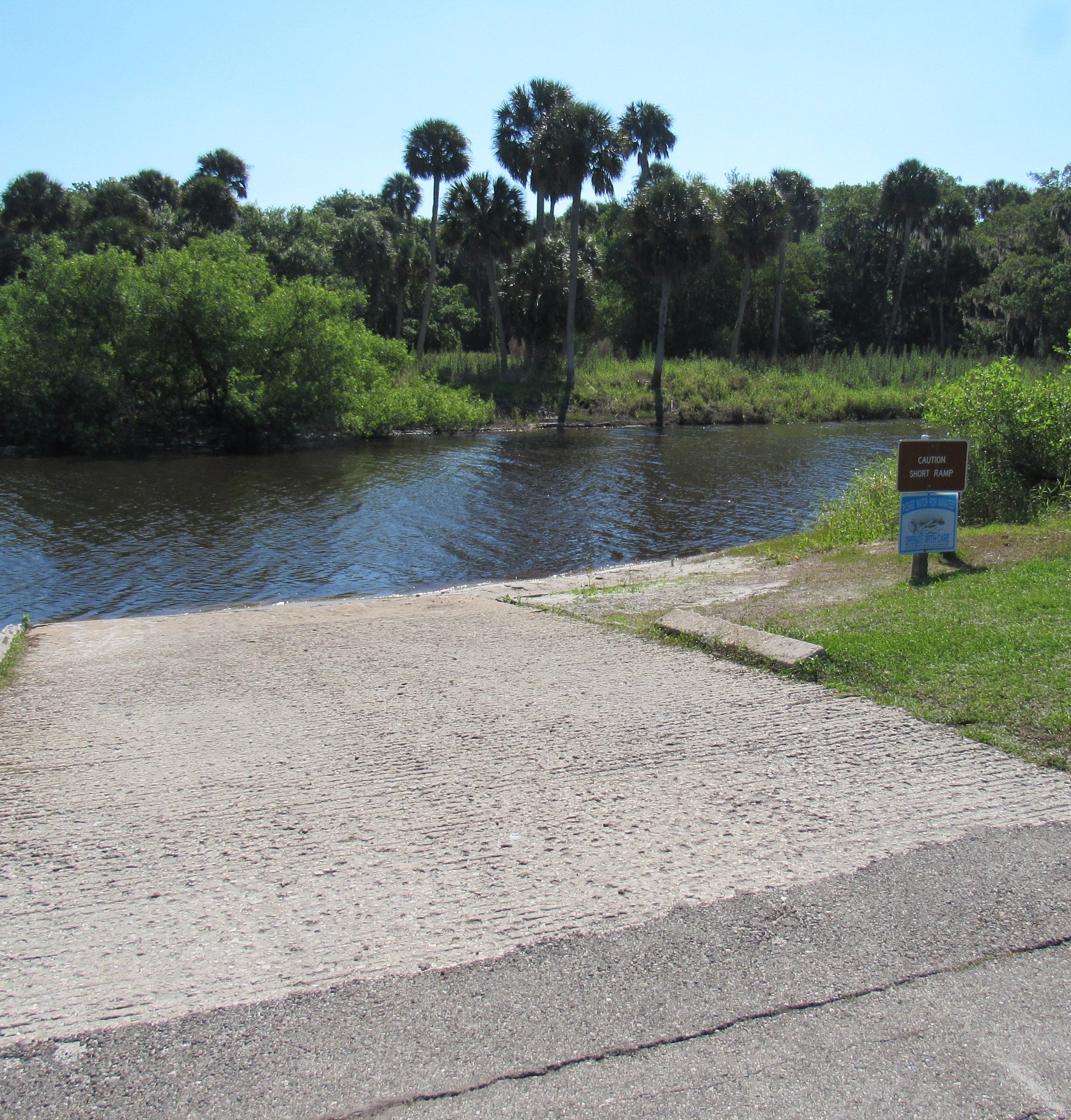 A paved ramp leads into the boat basin