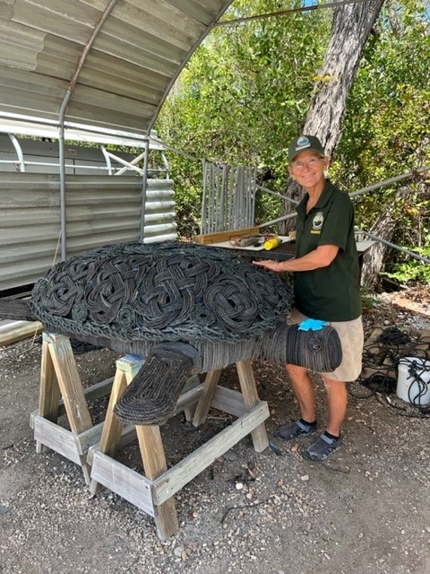 Jill Long with sea turtle sculpture.