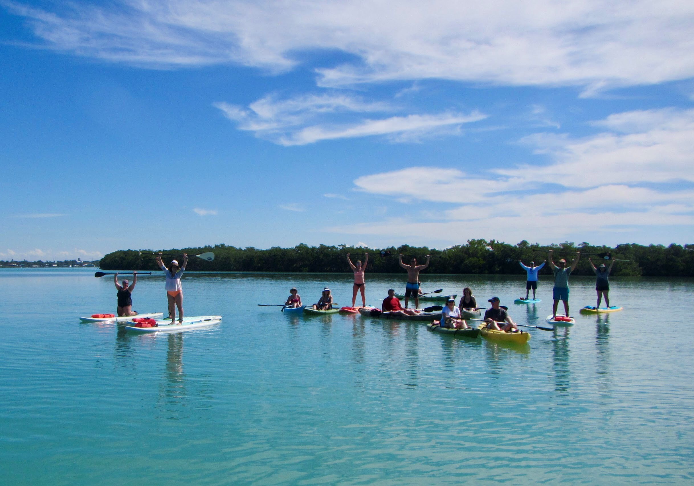 Group of people on kayaks and paddleboards in the water
