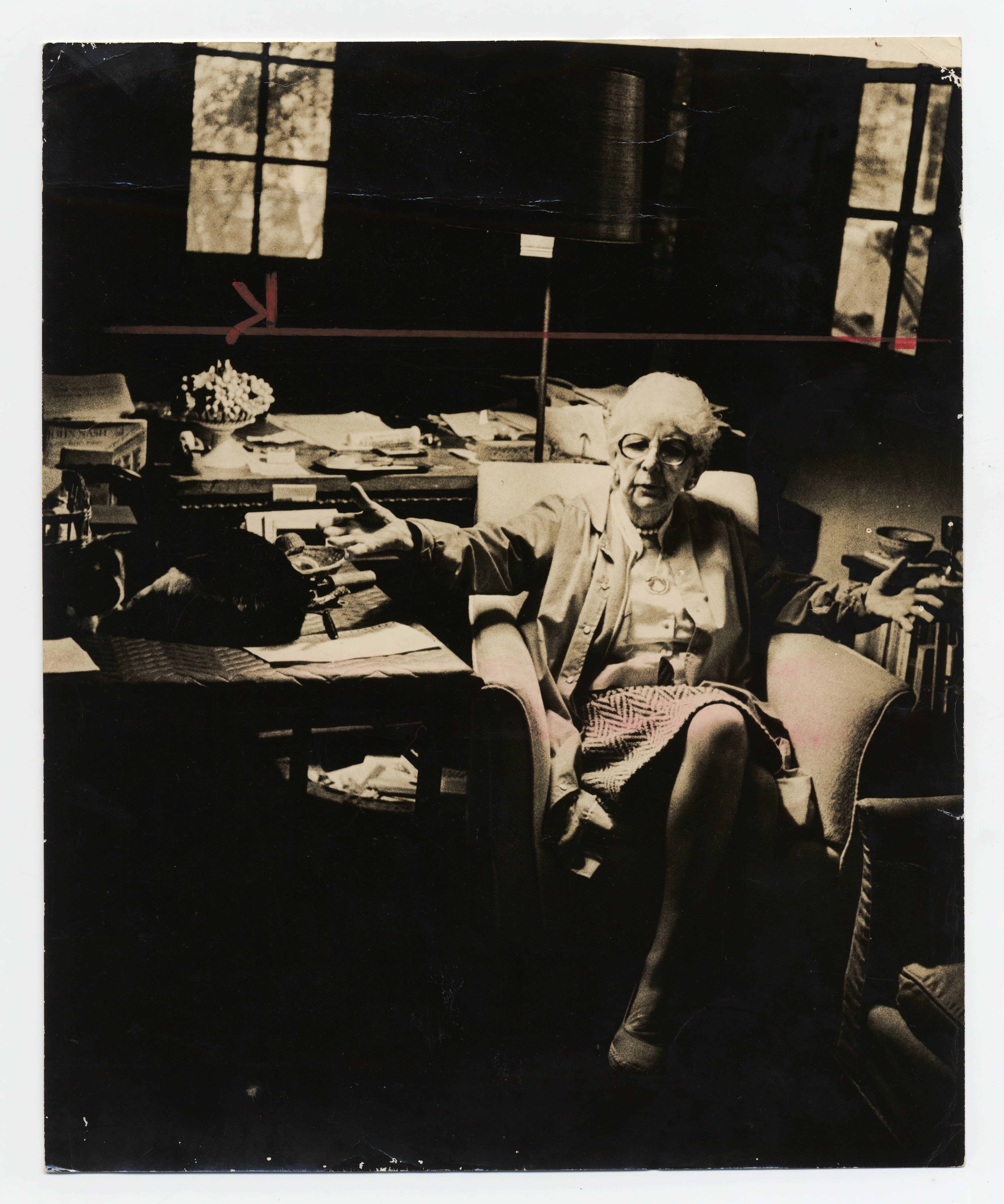 Surrounded by books, Marjory sits at her desk, 1981.