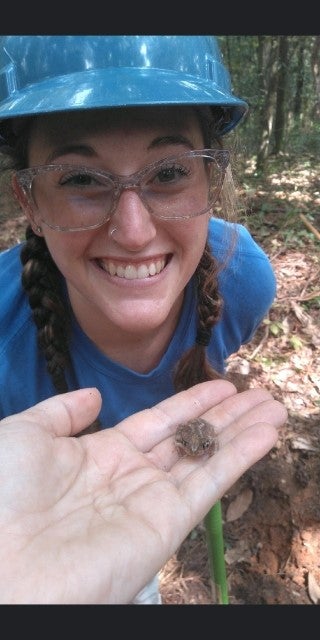 Someone shows Megan a tiny frog.