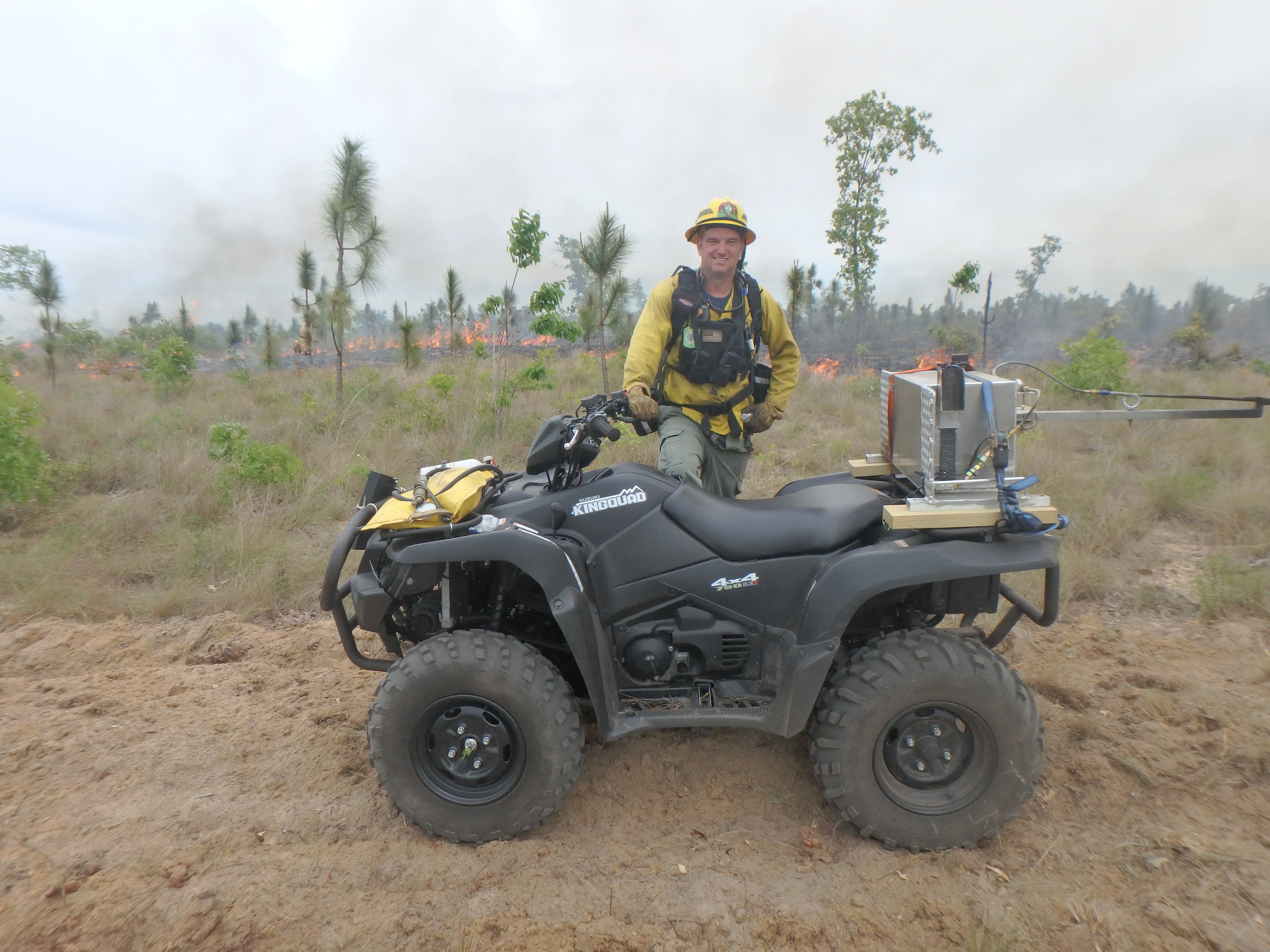 Jason vickery standing with an ATV. 