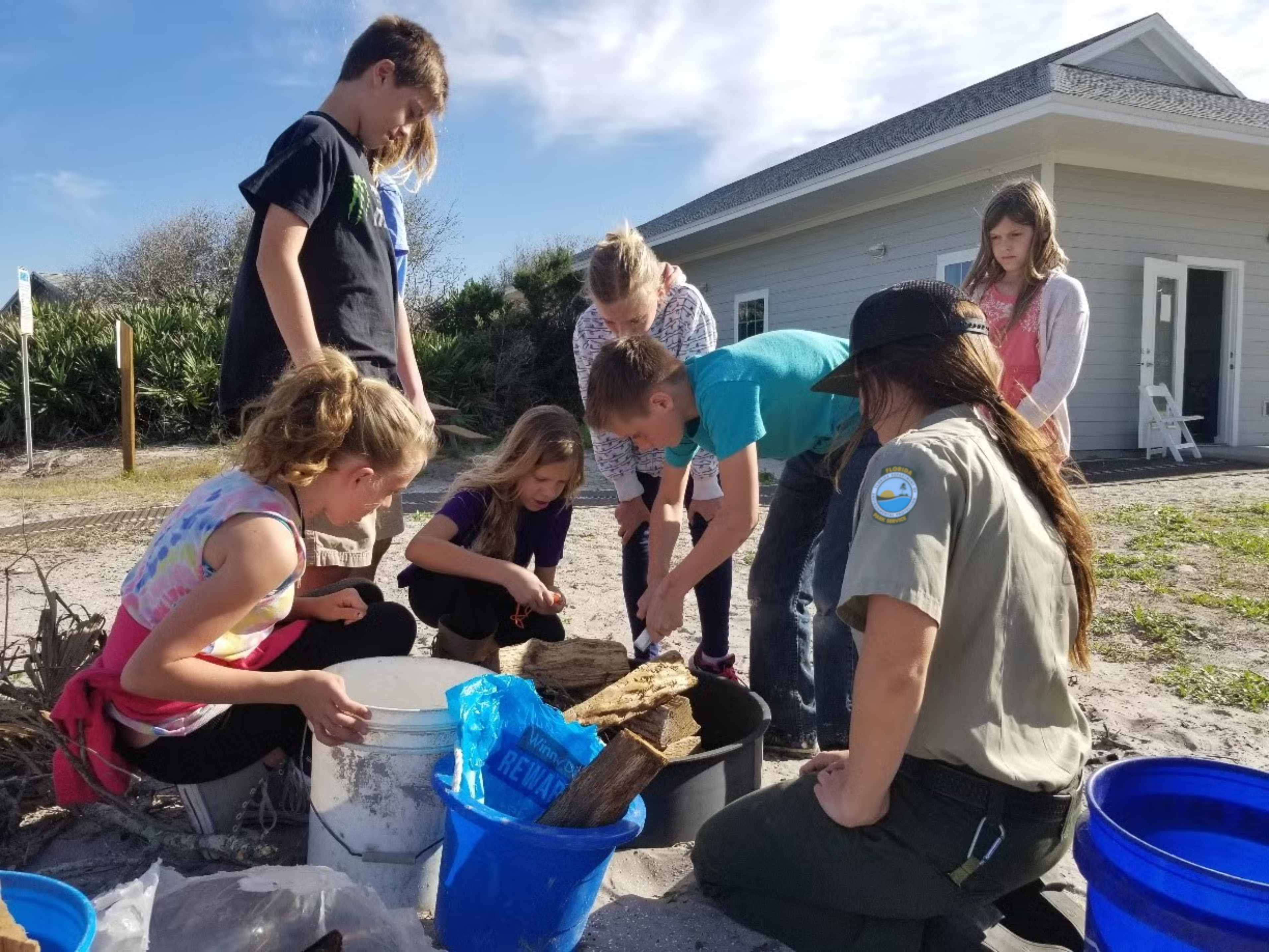 A group of Junior Rangers doing a project with pieces of wood. 