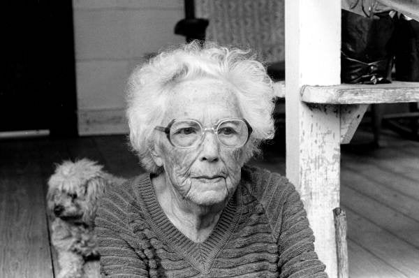 Myrtle Dudley on the porch with her dog