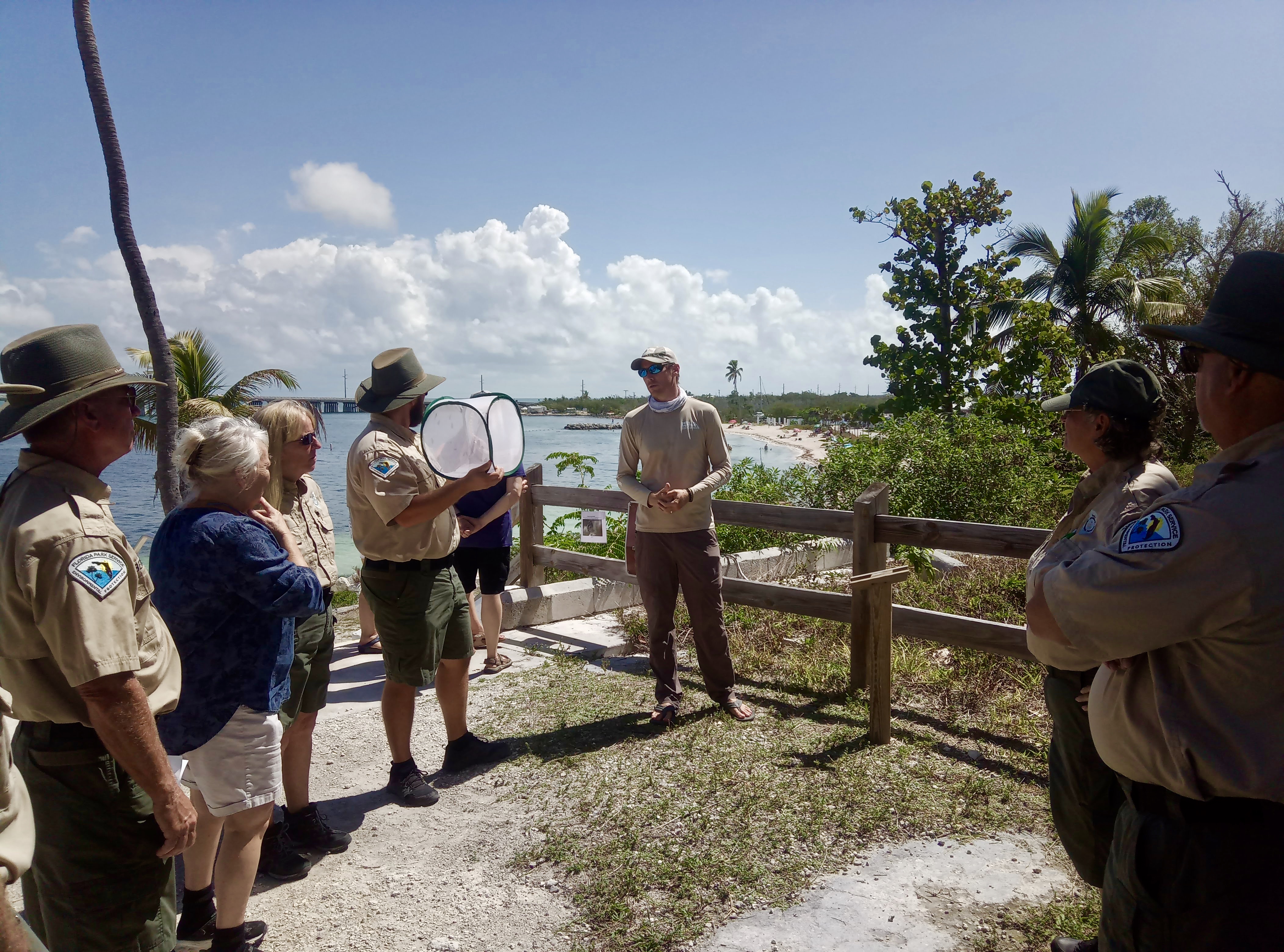 Staff members and volunteers gather at Bahia Honda State Park to learn about the releases of the Miami blue butterfly.