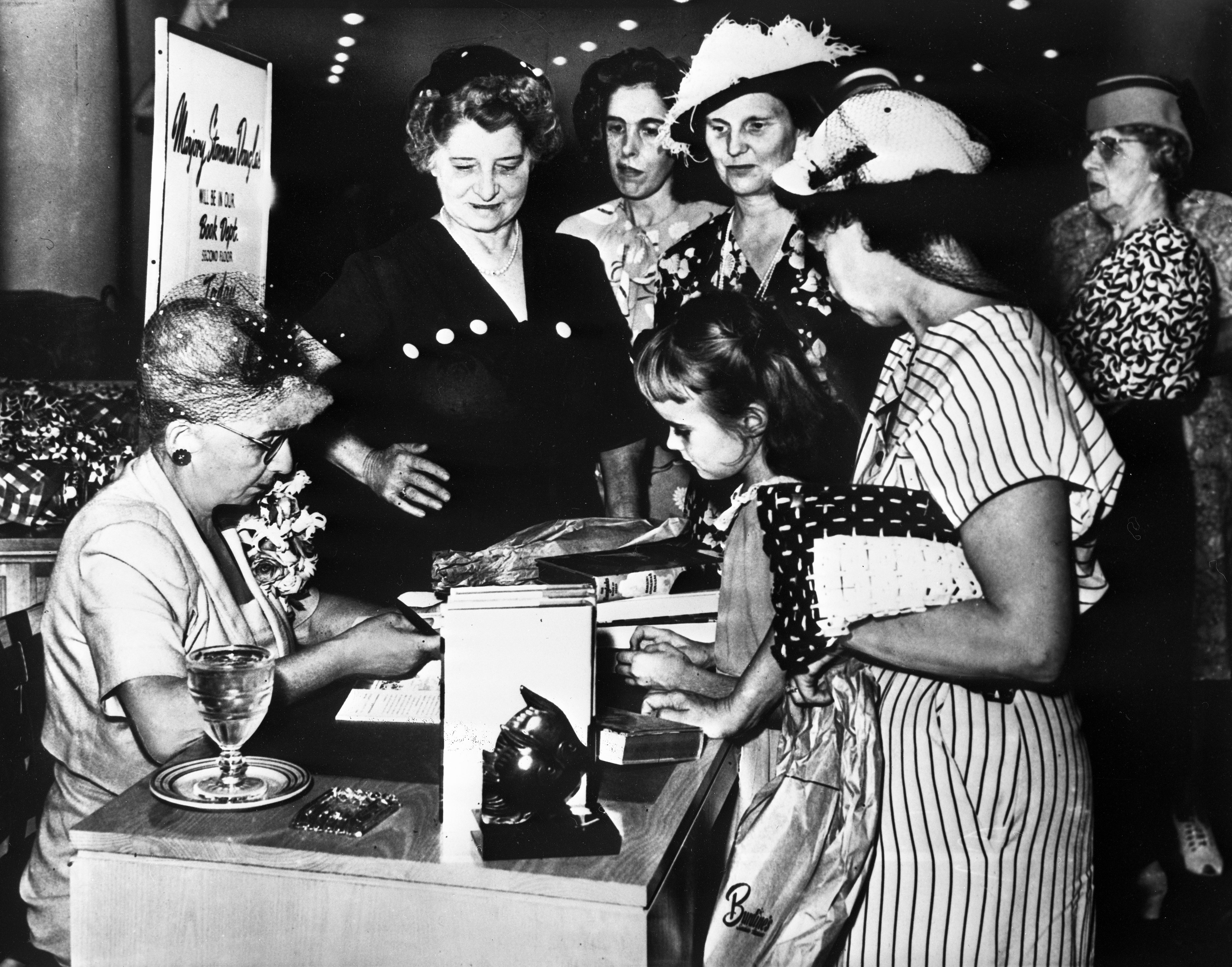 Marjory signs copies of River of Grass in a Burdines Department Store, 1947.