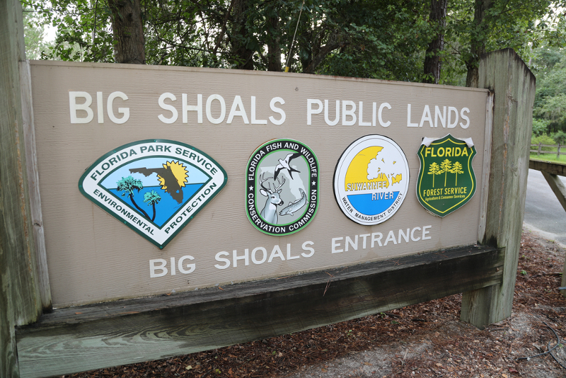 a large sign with multiple seals of different agencies reads "big shoals public lands, big shoals entrance"
