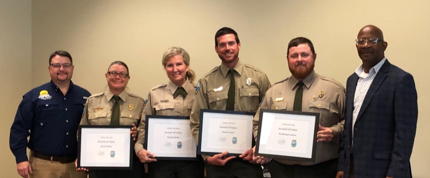 Brian Fugate and BJ Givens present the 2022 Award of Valor to the Koreshan State Park team.