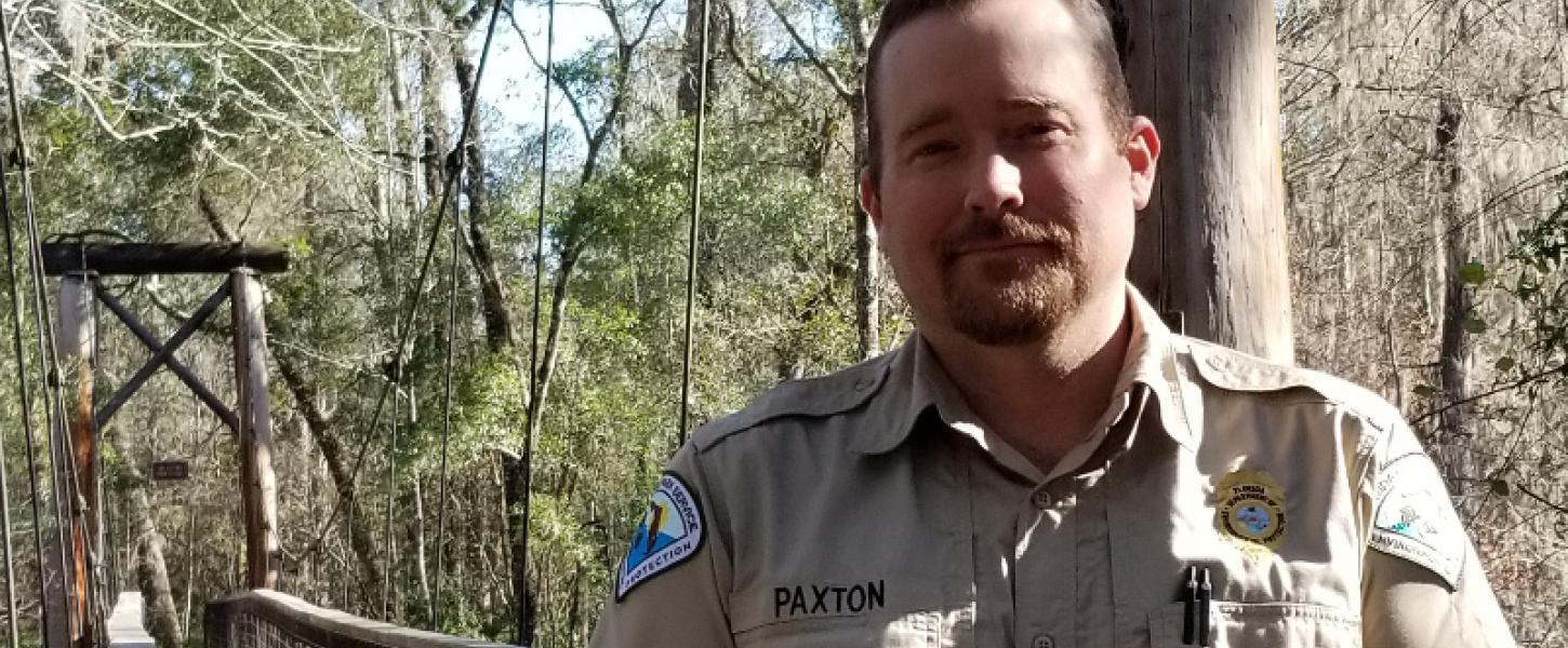 image of george paxton, park manager, standing by a ccc bridge.