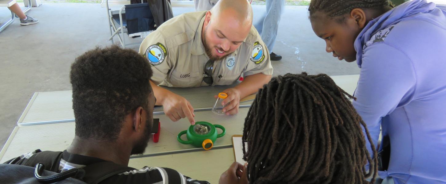 Park ranger leading a program for young visitors at a Florida state park