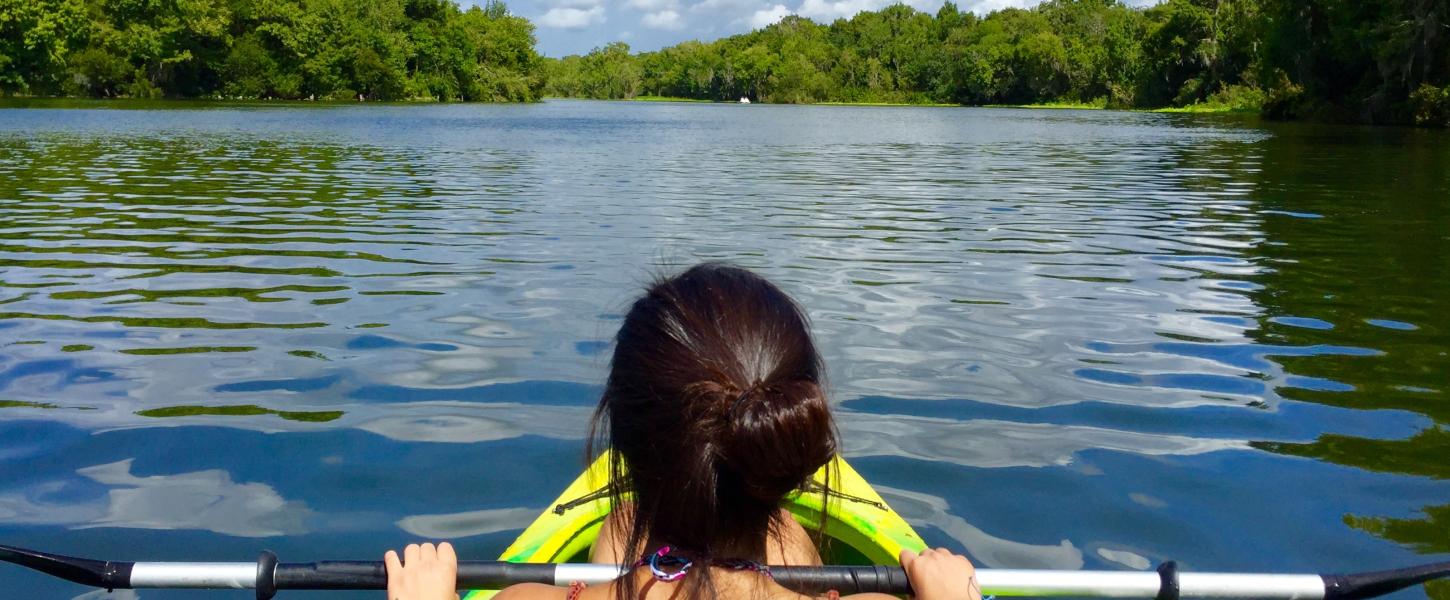A kayaker takes in the view on the water.