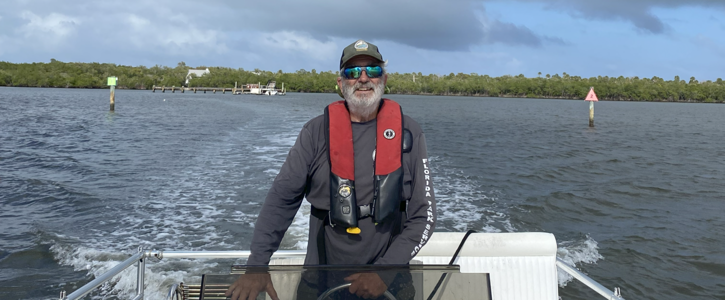 man driving boat through water