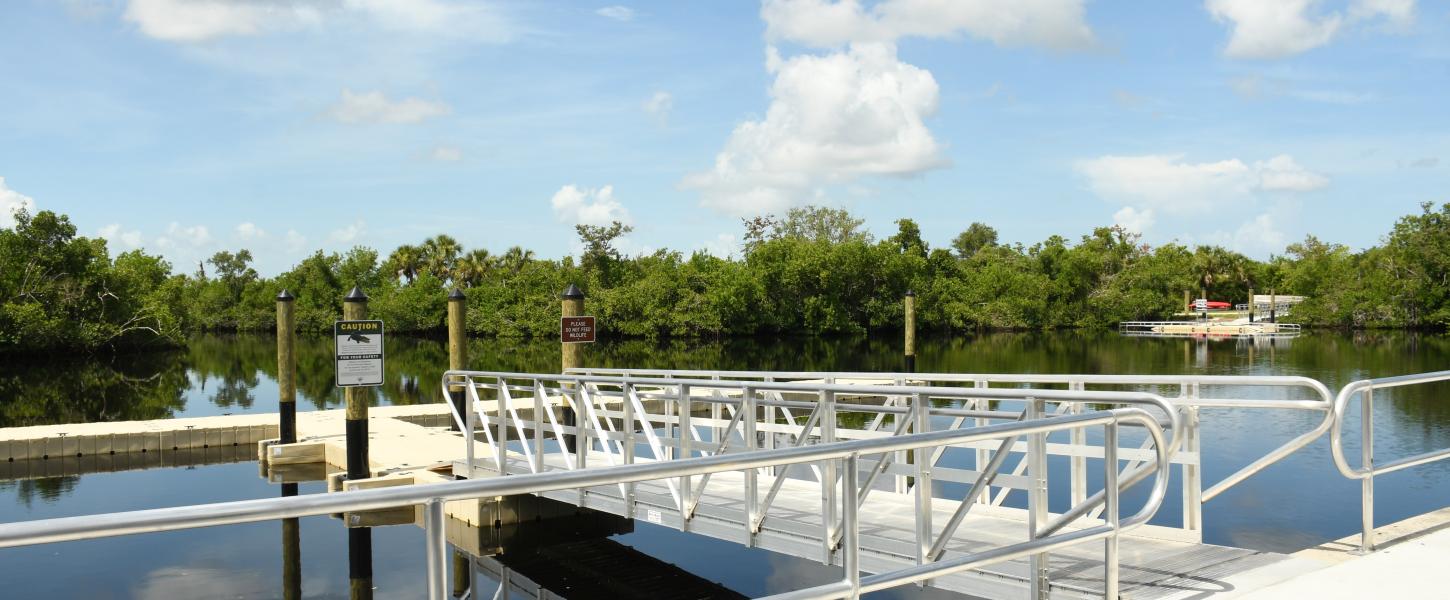 River with floating boat dock and canoe launch.