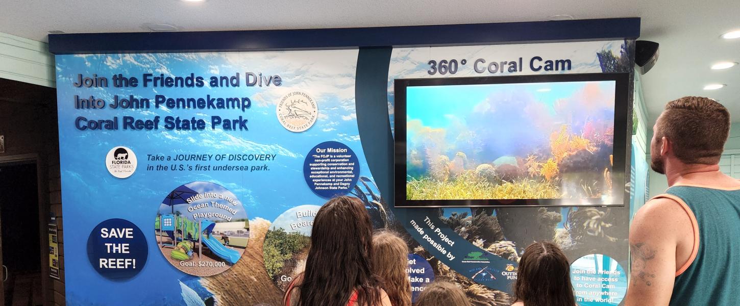 Visitors watch the coral cam from the exhibit inside the visitor center.
