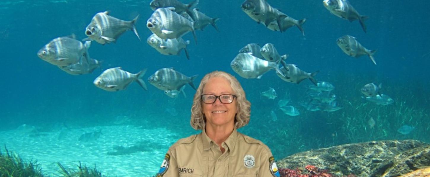 Cyndy Emrich in front of fish.