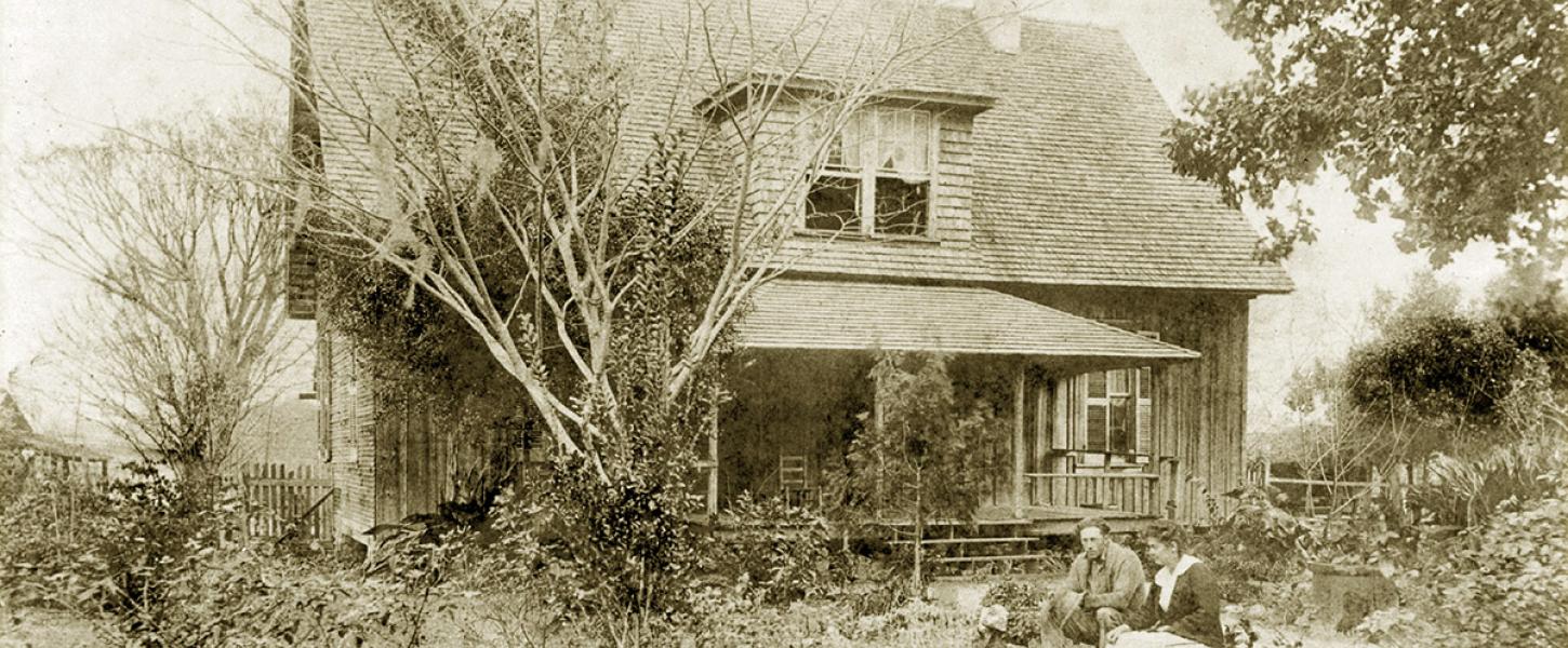 The Dudley farmhouse with Norman and Winnie sitting in front from 1915