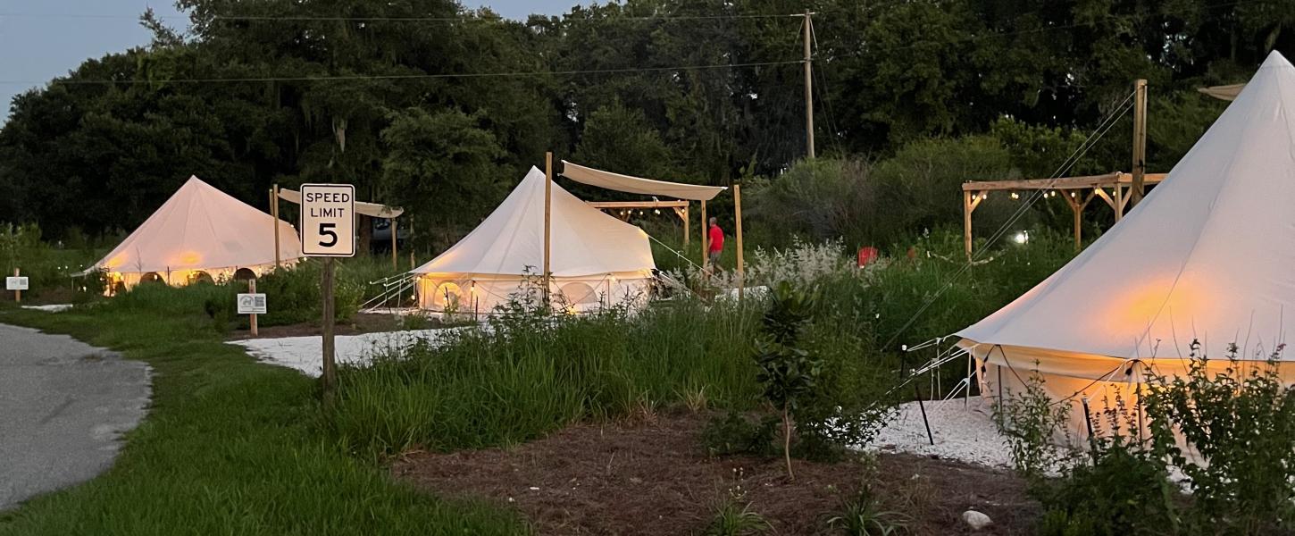 Three glamping pads at dusk.