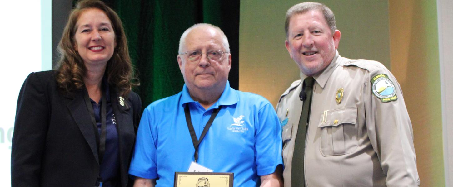 Don Philpott receives the award with Tammy Gustafson and Chuck Hatcher.