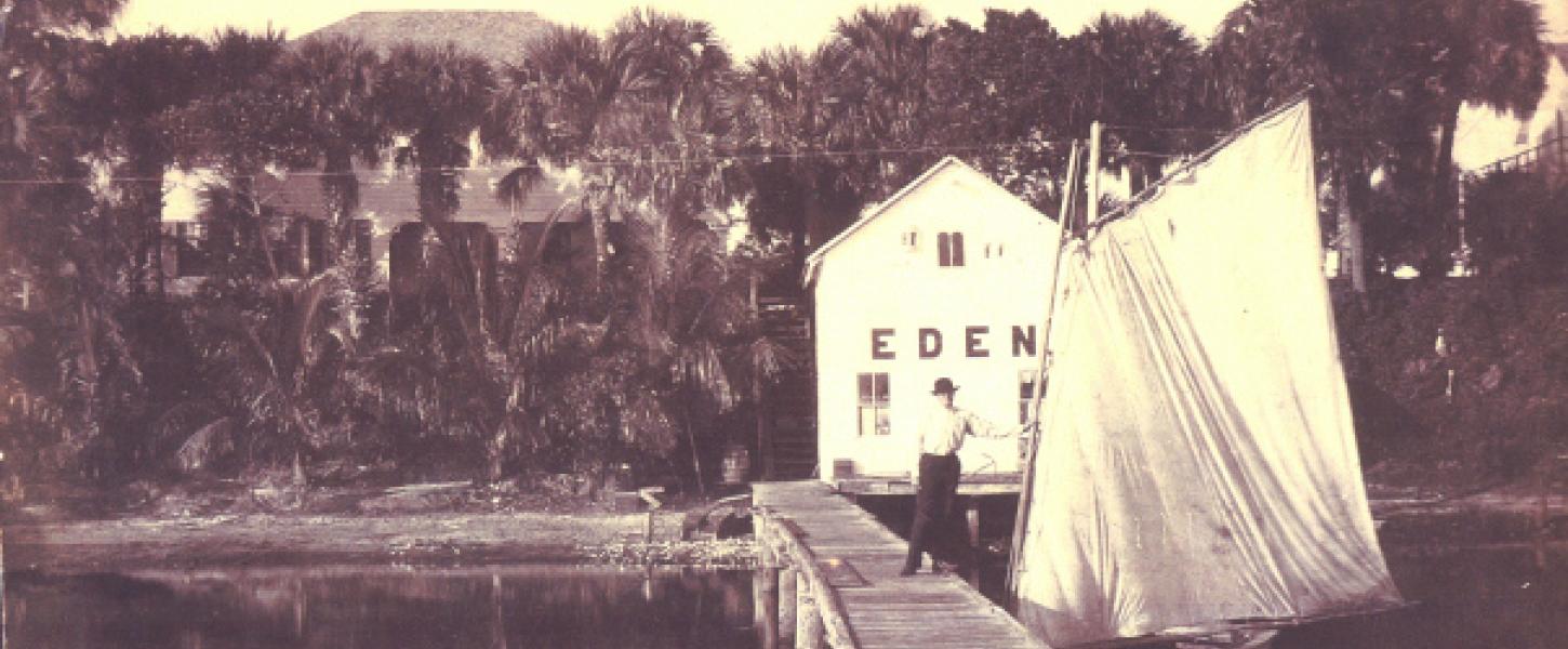 A boathouse and dock rest on the shoreline of the Indian River Lagoon.