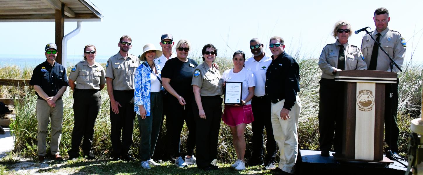 group of award winning volunteers stand with proud park staff