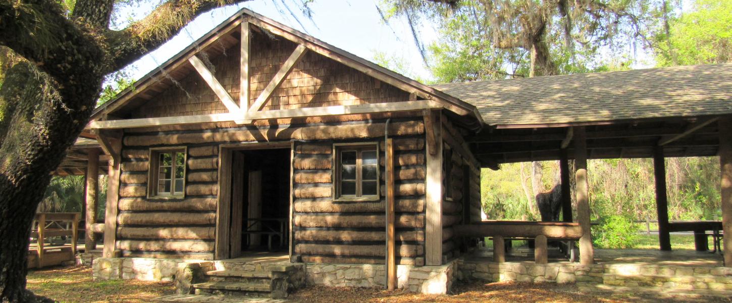 The Log Pavilion in the shade of a Live Oak