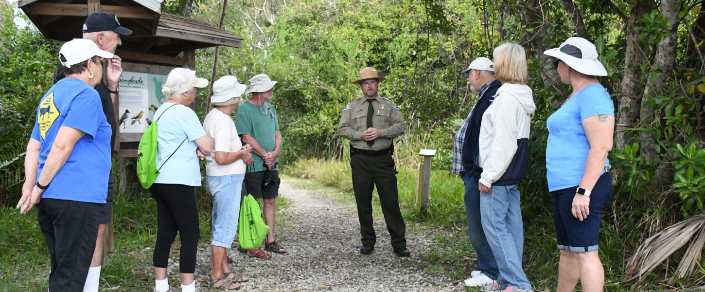 A view of a group of visitors going on a nature walk.
