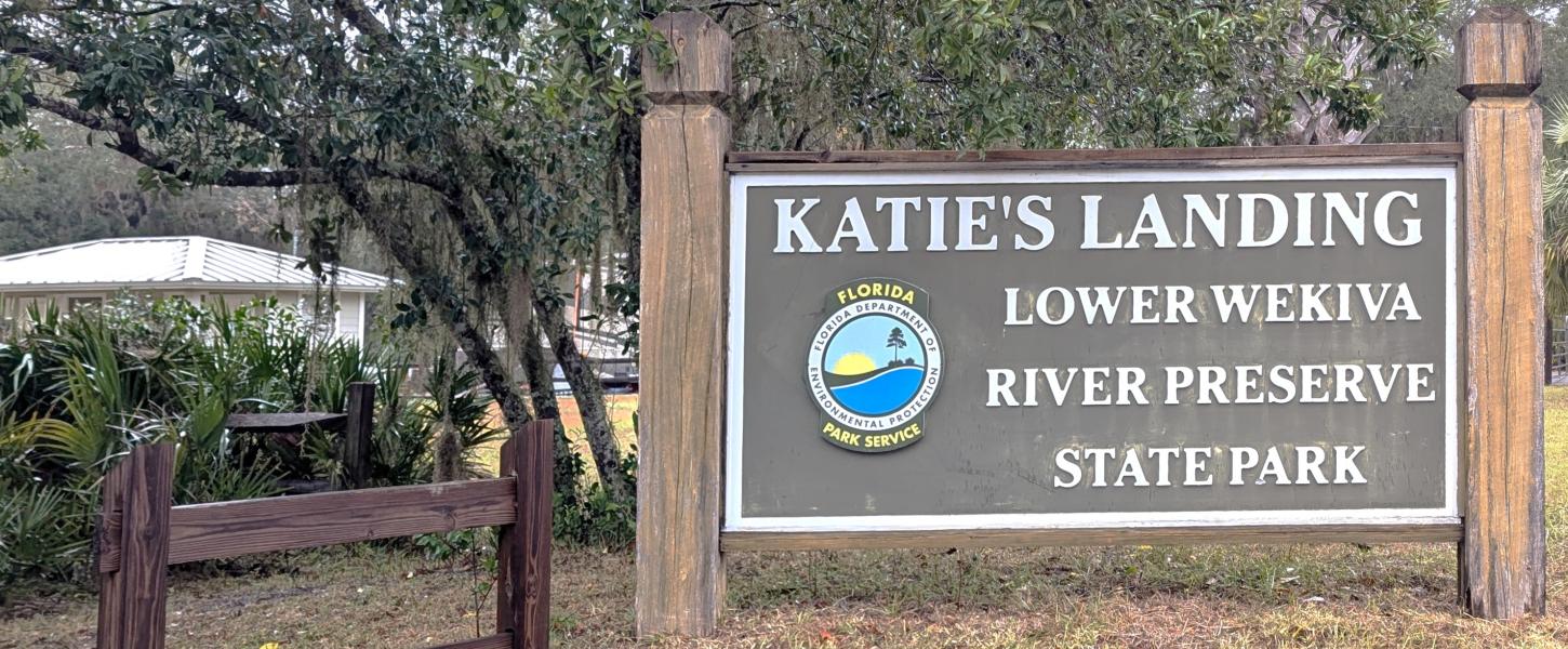 A sign that reads "Katie's Landing Lower Wekiwa River Preserve State Park".