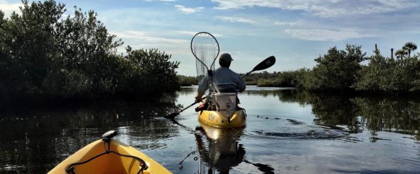 Two yellow kayaks with fishing gear at Gamble Rogers