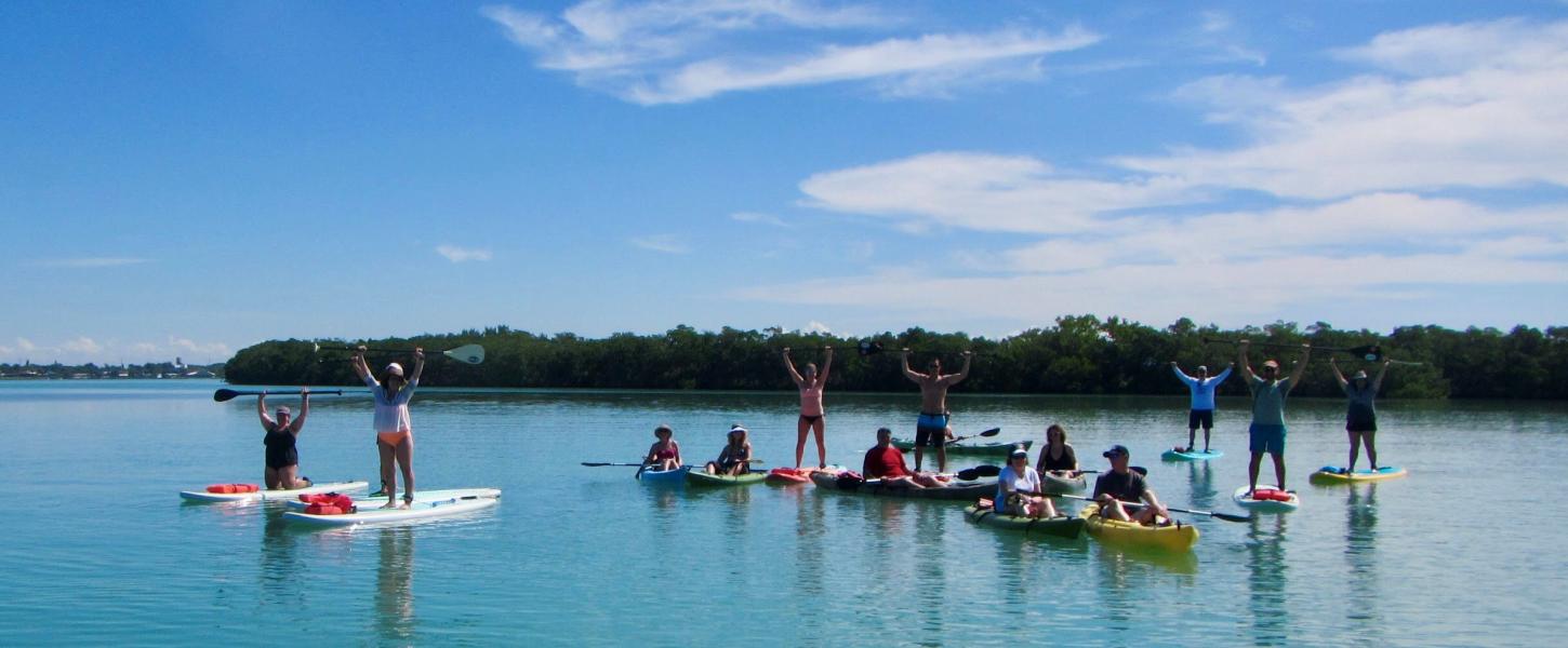 Group of people on kayaks and paddleboards in the water