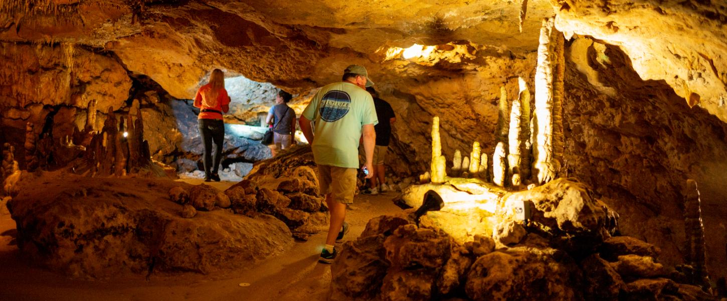 Three people on a cavern tour.