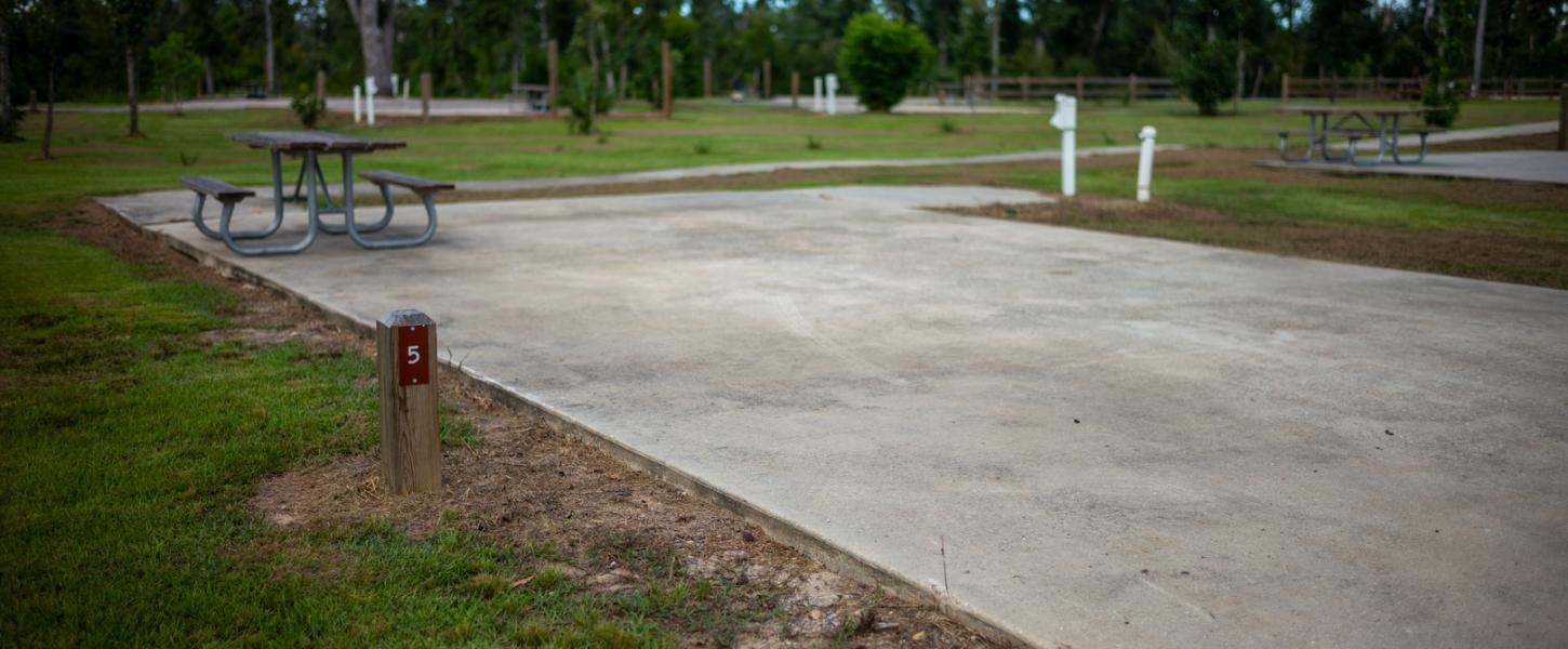 A concrete pad marks one of campsites in the campground at Florida Caverns State Park.  