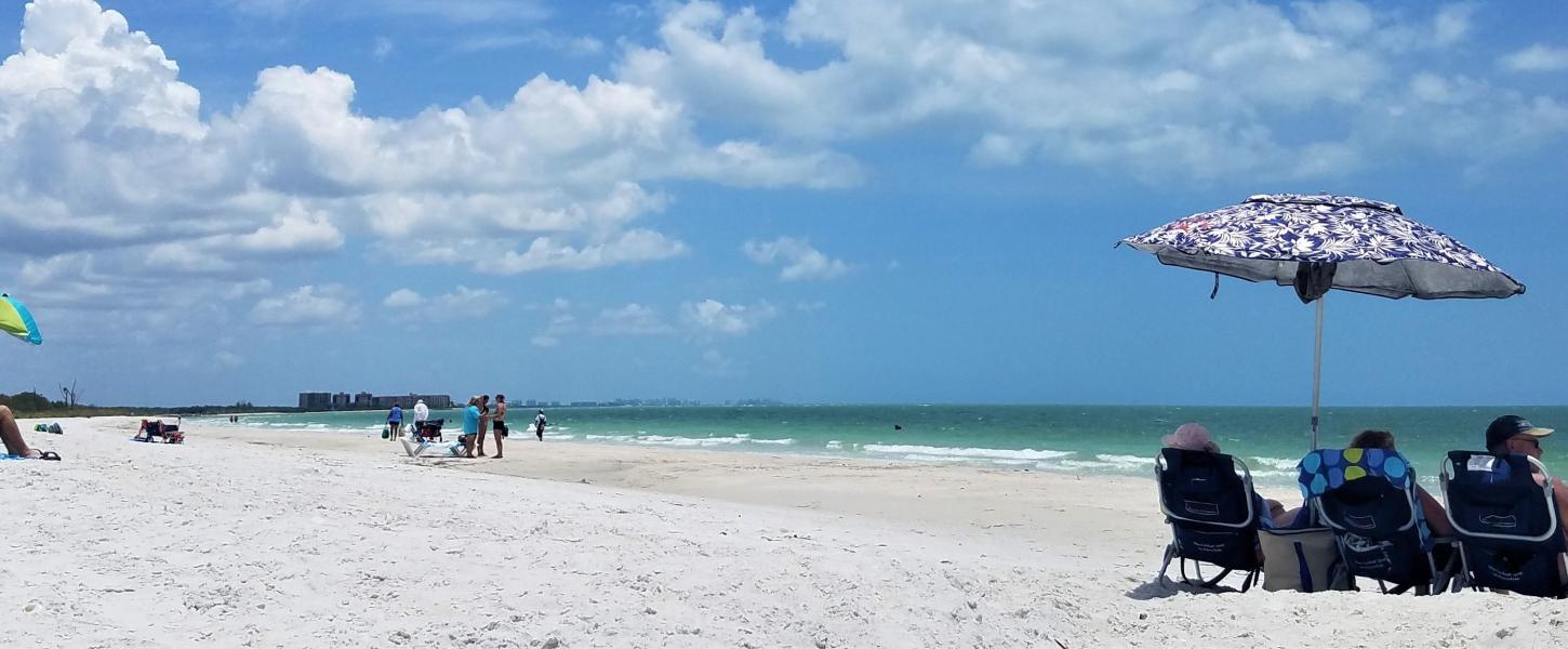 A view of people sunbathing along the beach.