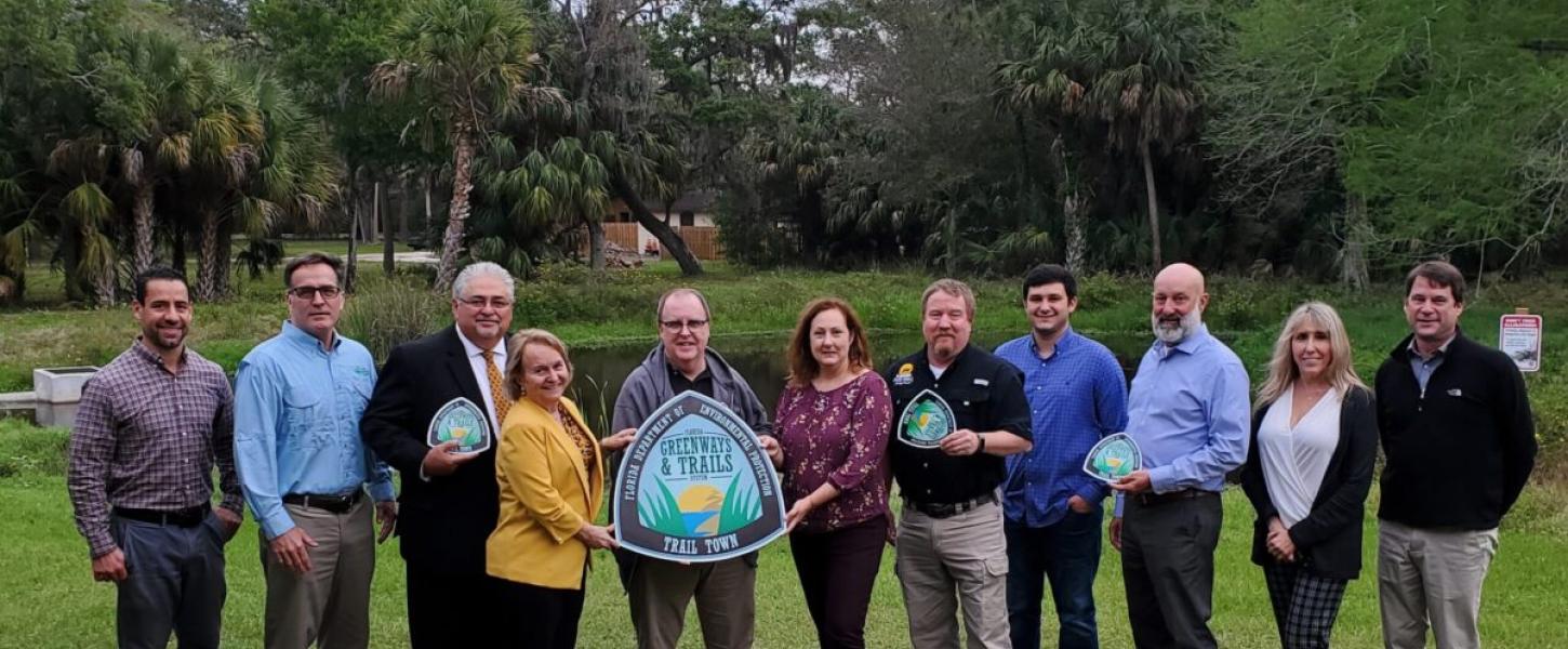 People posing with the City of DeBary 