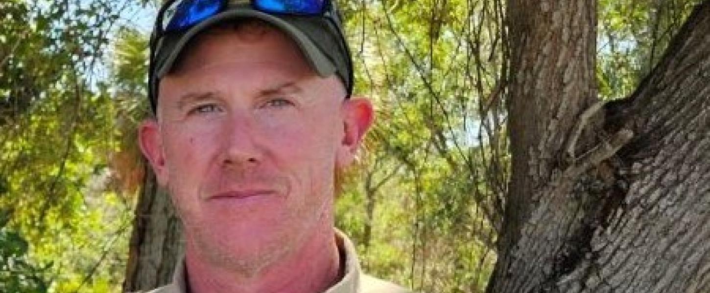 Jeffery standing in front of trees.