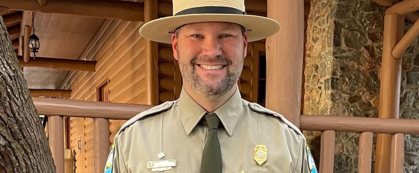 Wesley smiling in front of the Lodge