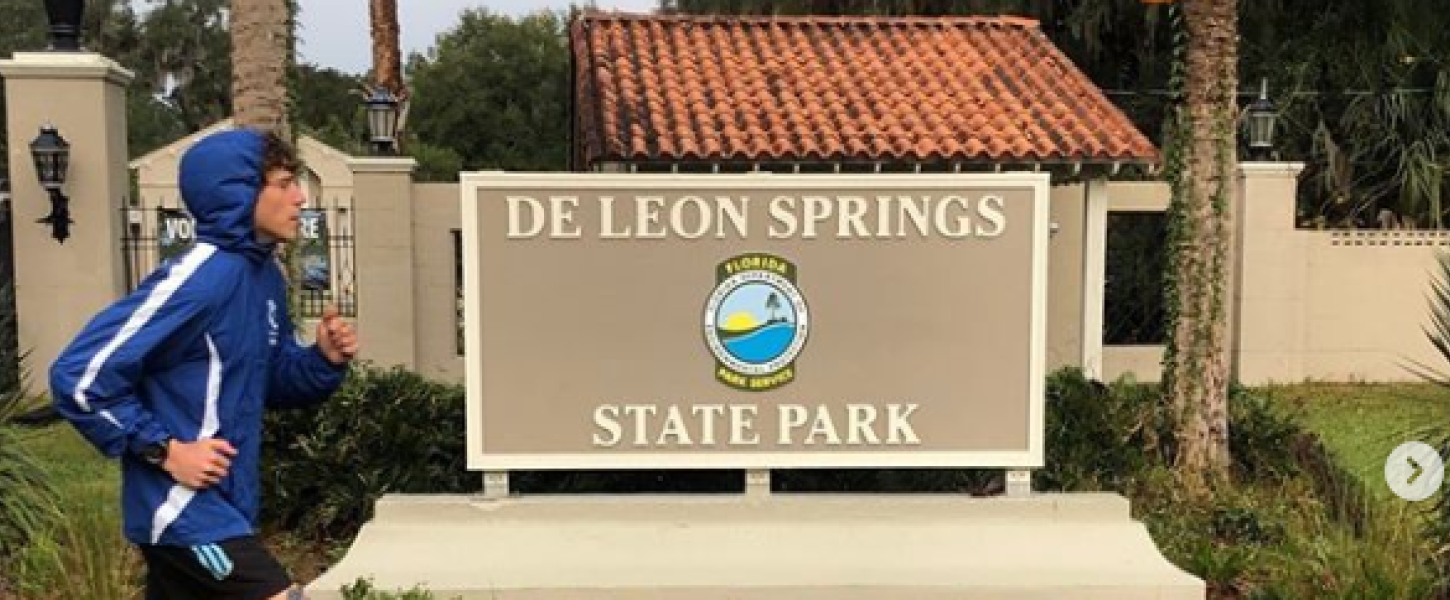 Charles Richardson runs past park sign at De Leon Springs State Park. 