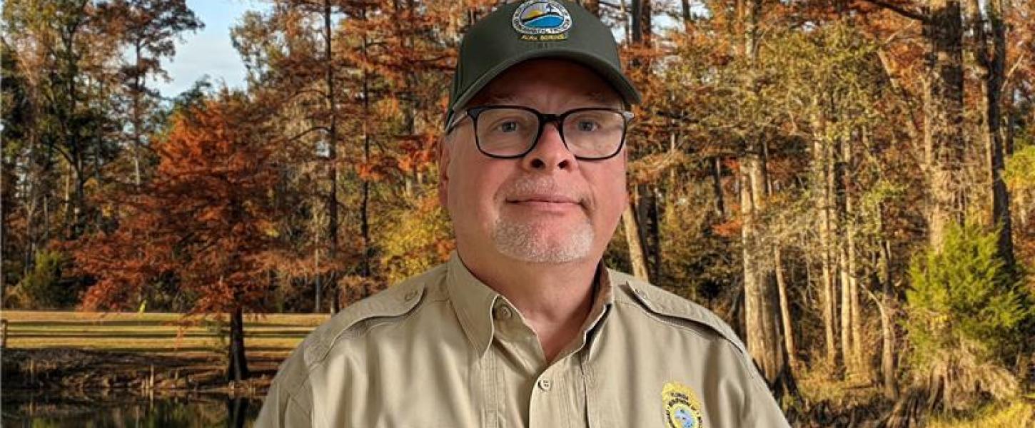Steve Cutshaw in front of trees.