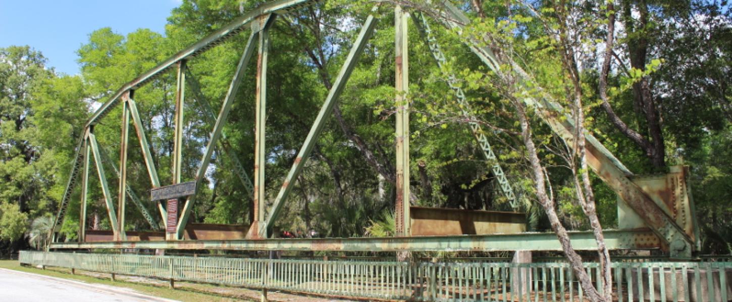 an old bridge sits on dry land